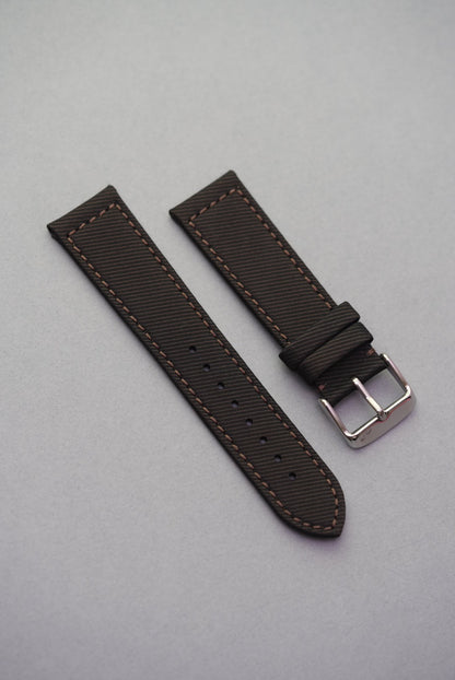 Textured clay brown recycled watch strap with matching brown stitching and brushed buckle, crafted from gabardine for a structured finish.