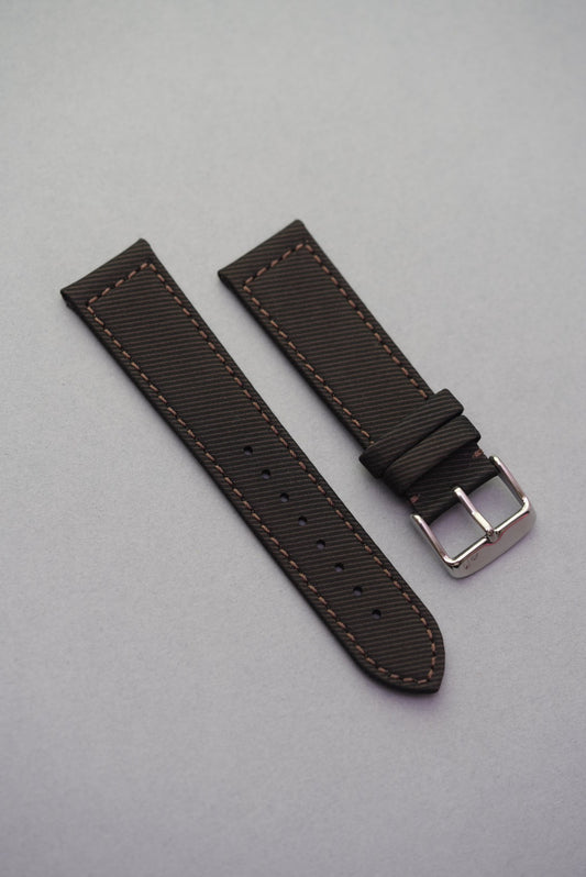 Textured clay brown recycled watch strap with matching brown stitching and brushed buckle, crafted from gabardine for a structured finish.