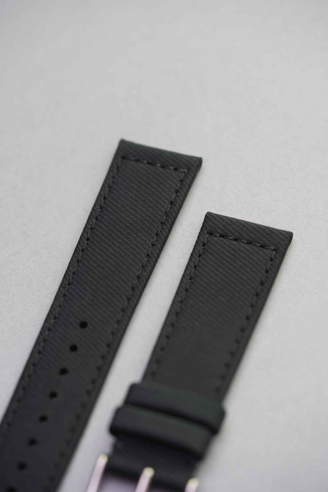 Detailed image of the Coal Black strap’s tonal stitching and durable remborded edge construction.