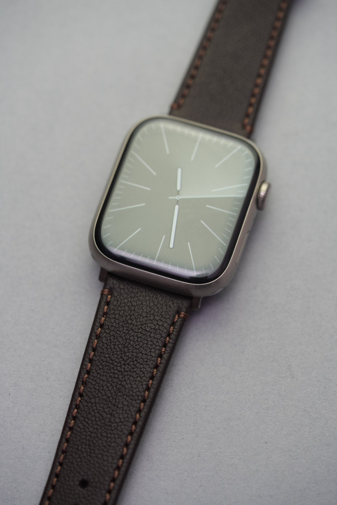 Cortado Chestnut sheepskin strap fitted to Apple Watch, shown at an angle to highlight warm tones and texture.
