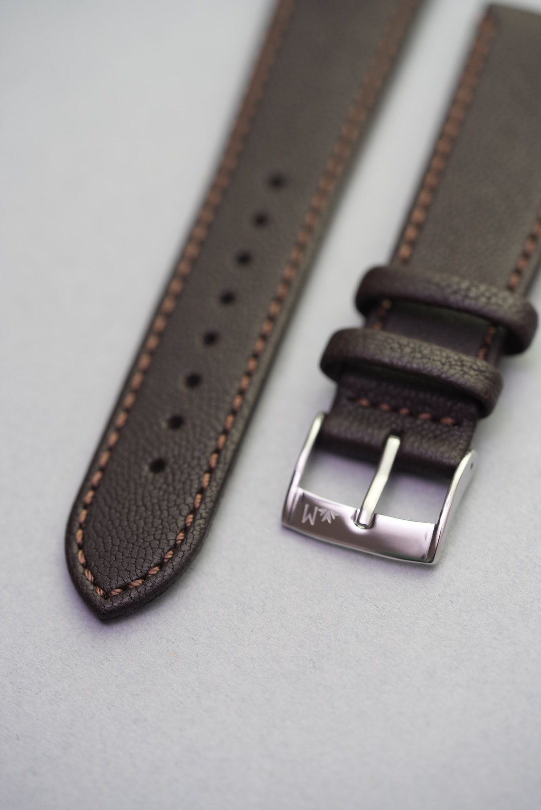 Detail view of Cortado Chestnut strap with polished buckle, soft grain texture, and coffee-toned stitching.
