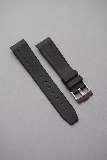 Matte black military-grade FKM rubber MoonSwatch strap with smooth detailing and precision curved fit.