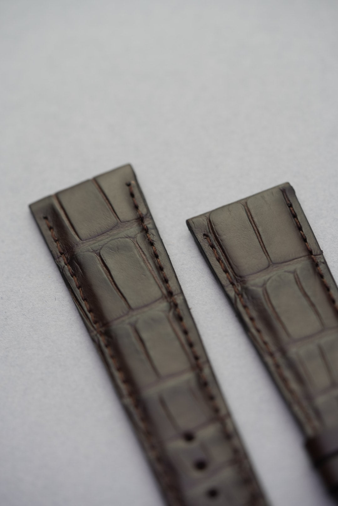 Close-up of lug area and embossed grain on dark brown alligator leather watch strap