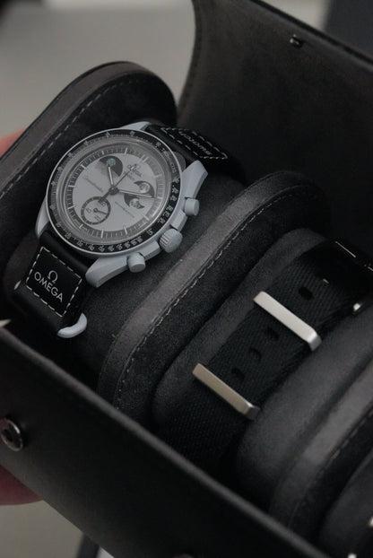 Luxury watch with black strap and detailed face on a wooden surface