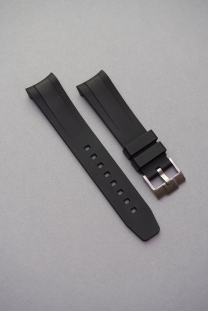 Black FKM curved rubber strap, brushed steel buckle, close-up