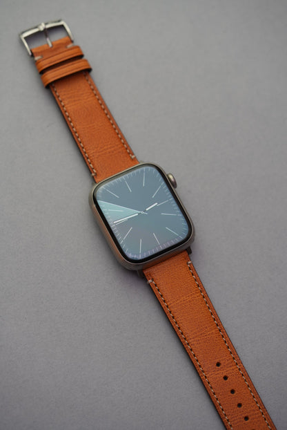Full view of golden brown fine grain leather strap on Apple Watch
