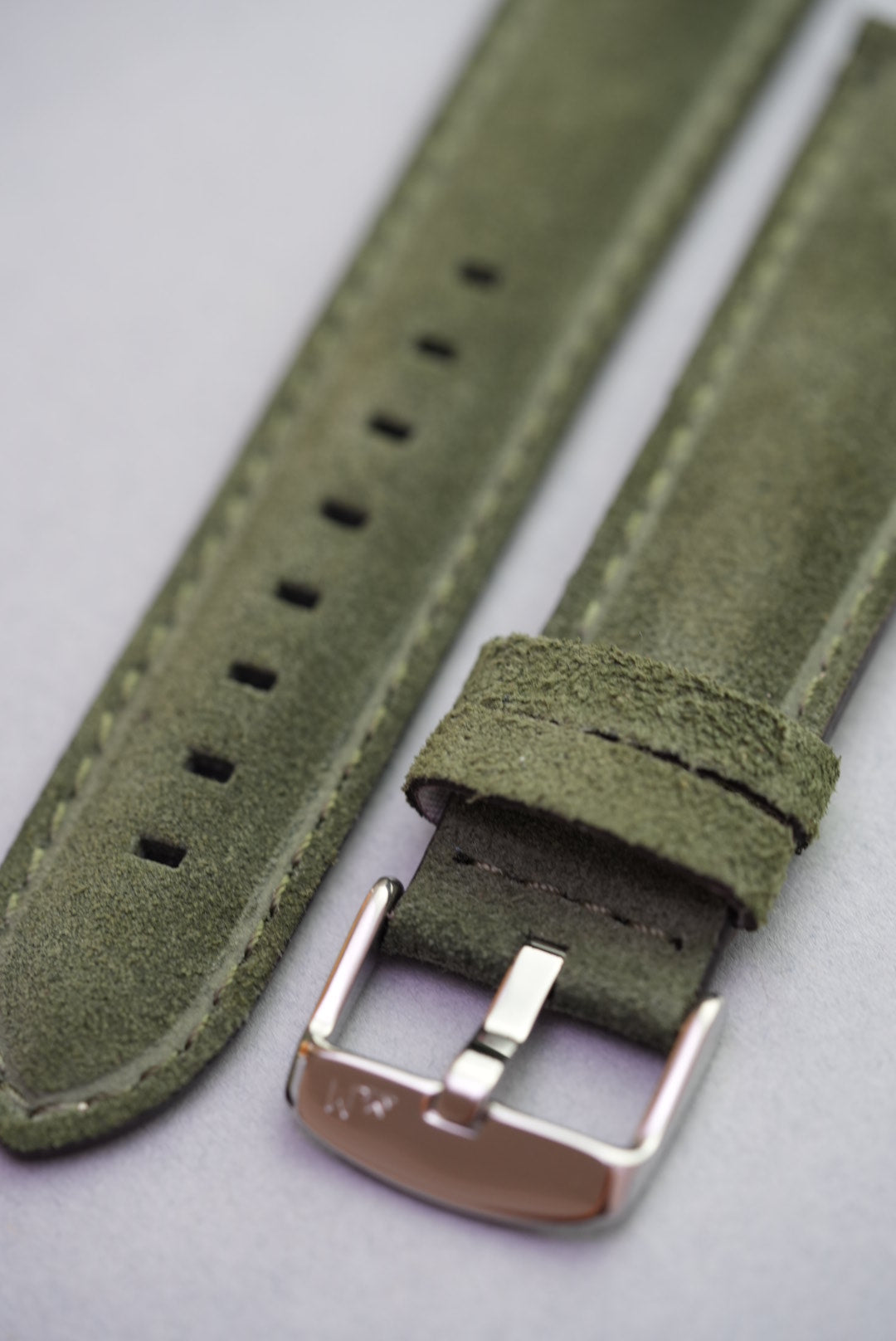Angled view of green suede leather strap showing keeper loops and stitching – strap replacement for standard watches