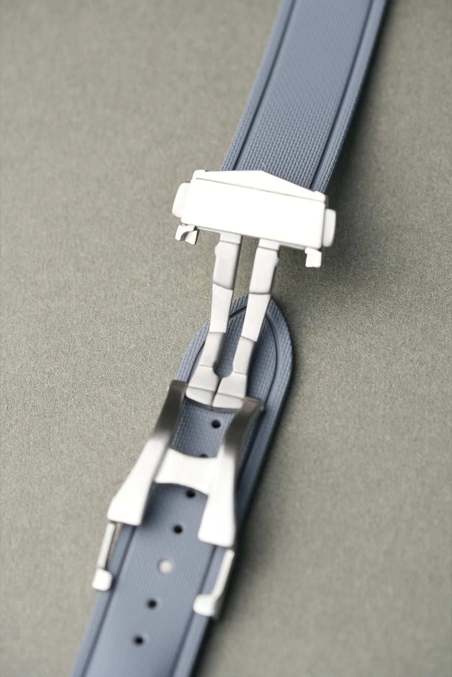 Gray belt with a silver buckle on a gray background