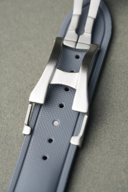 Gray belt with silver buckle on a gray background
