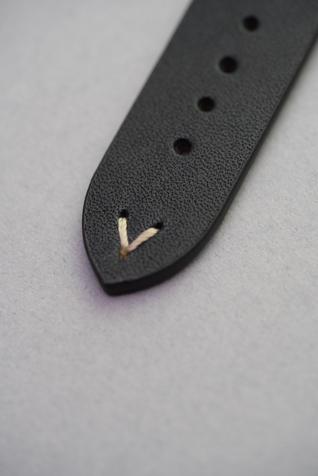 Black lug-stitched leather strap with Apple Watch adapters, perfect for replacing a standard silicone band.