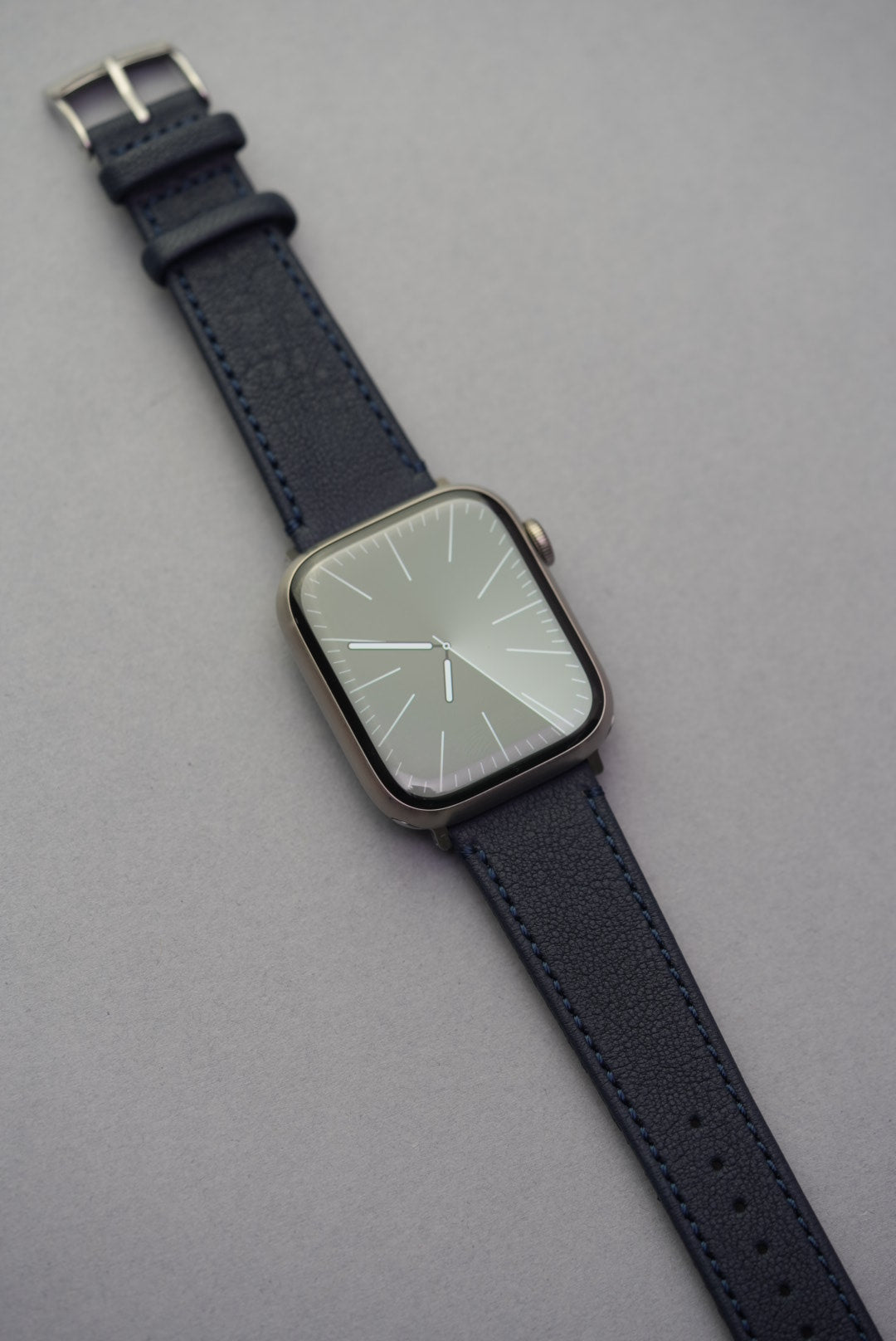 Midnight Capri sheepskin strap fitted to Apple Watch, showcasing deep navy grain leather and clean integrated fit.