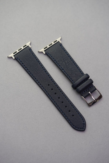 Apple Watch with Midnight Capri strap in soft matte sheepskin leather and matching blue stitching, shown full length.