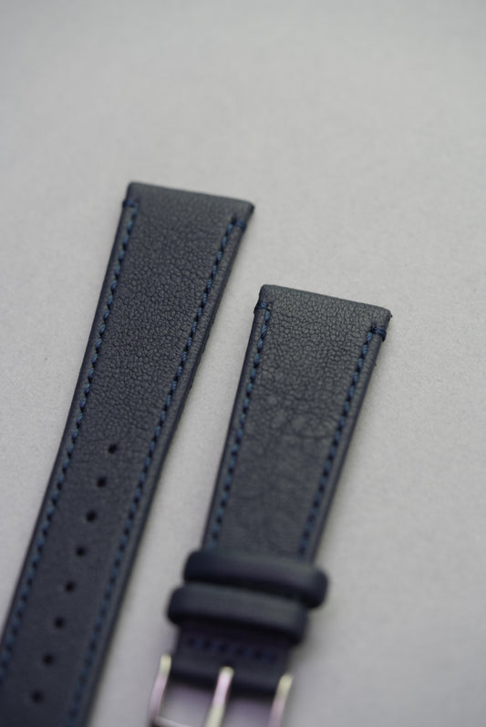 Close-up of Midnight Capri sheepskin strap buckle, highlighting stitching and grain texture.