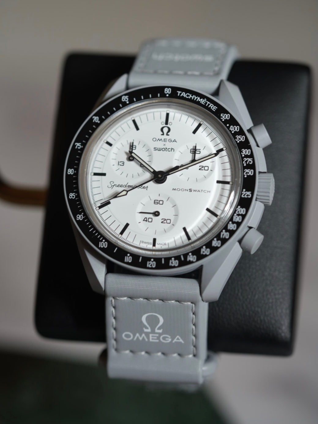 MoonSwatch 1965 — black Bioceramic case with red Flight Qualified chronograph hands, front view