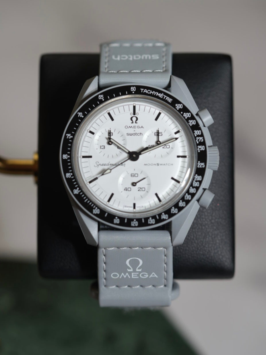 MoonSwatch 1965 dial close-up — black dial with chronograph accents and tachymeter bezel