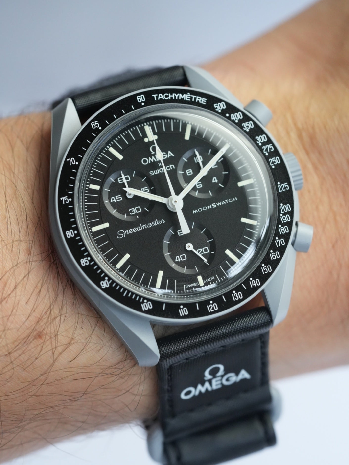 MoonSwatch Mission to the Moon — side profile showing grey Bioceramic case and black velcro strap