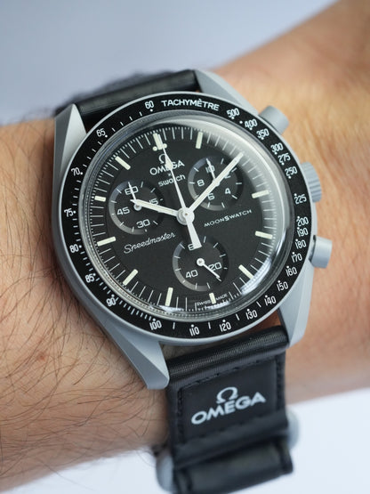 MoonSwatch Mission to the Moon — side profile showing grey Bioceramic case and black velcro strap