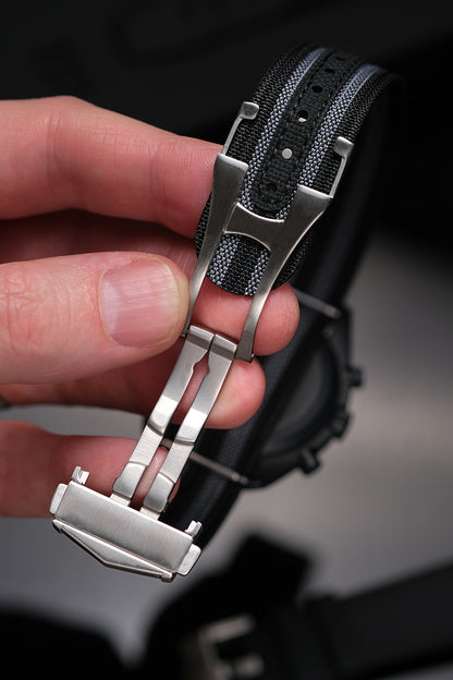 MoonSwatch nylon strap — FKM rubber reinforced notch holes close-up showing stitching and weave detail