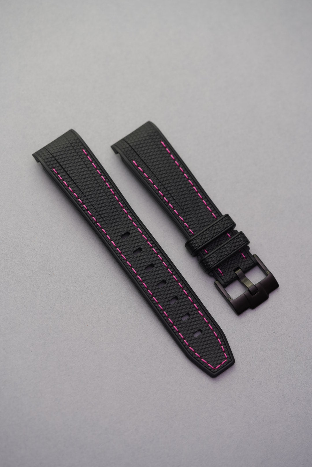 Swatch x Omega MoonSwatch Mission to the Pink Moonphase shown flat with a black rubber strap and vibrant pink stitching – modern and bold aesthetic.