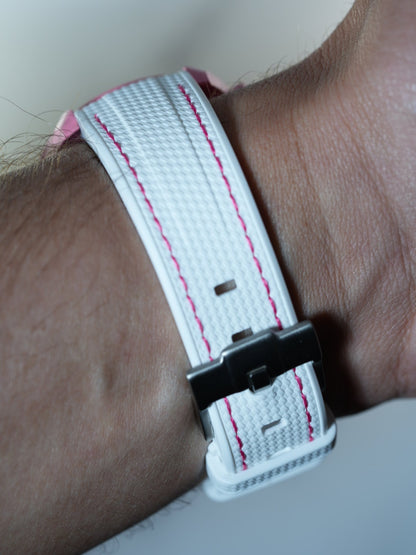 Close-up of the stainless steel buckle and textured white strap with pink stitching – secure and polished design.