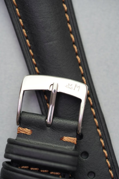 Close-up of stainless steel Morellato buckle on black leather strap