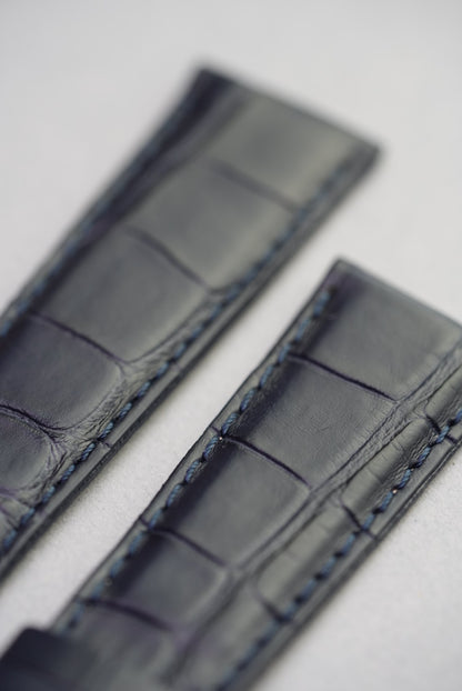 Close-up of blue stitching and grain on navy alligator embossed leather watch strap