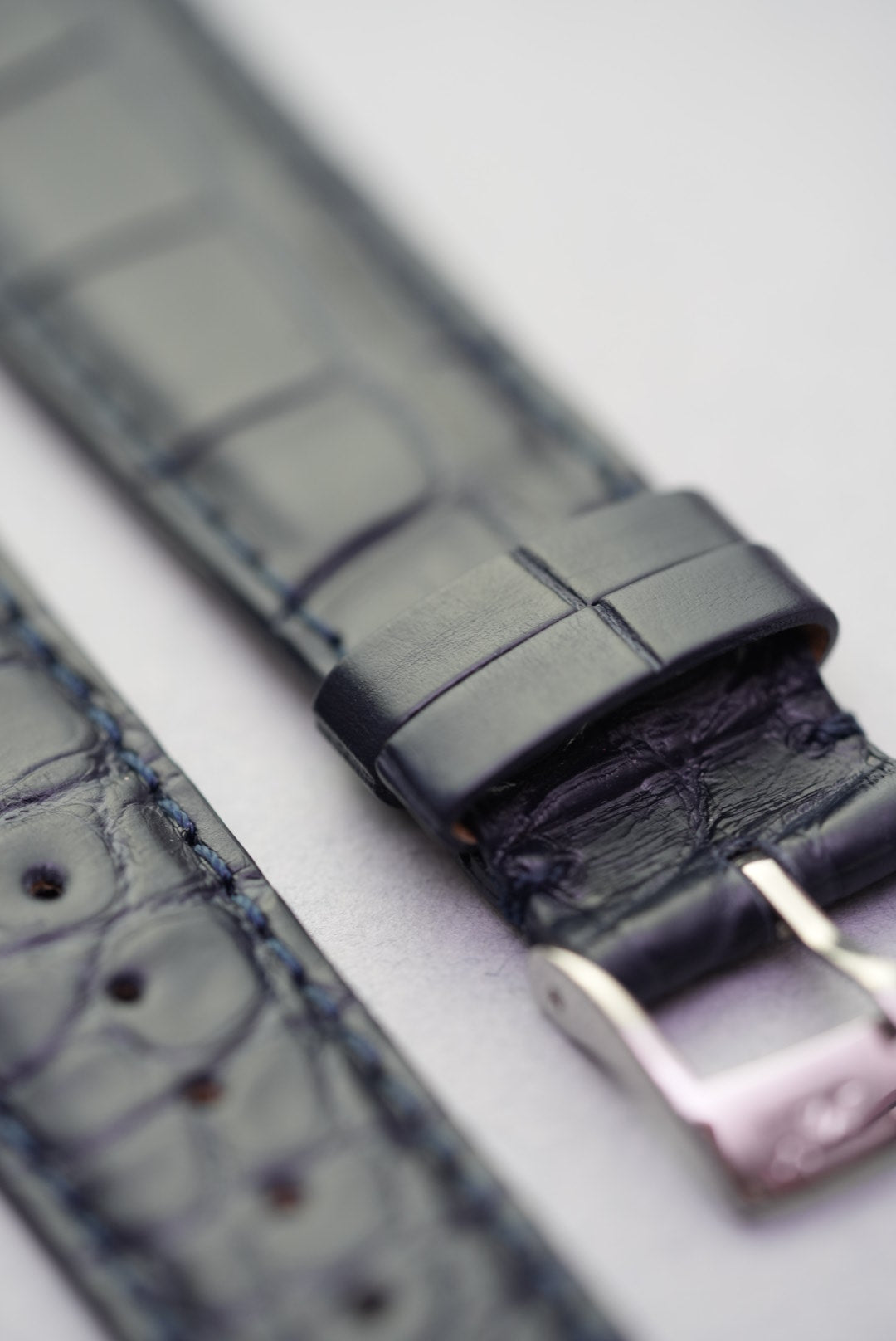Keeper loop and embossed grain detail on navy alligator leather strap for watches