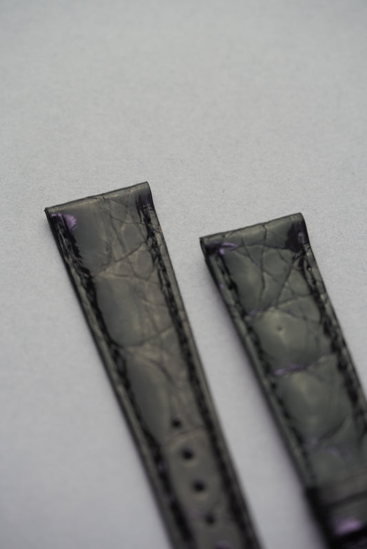 Close-up of the upper ends of the Noir crocodile leather strap for Cartier, showing rich scale definition and deep gloss.