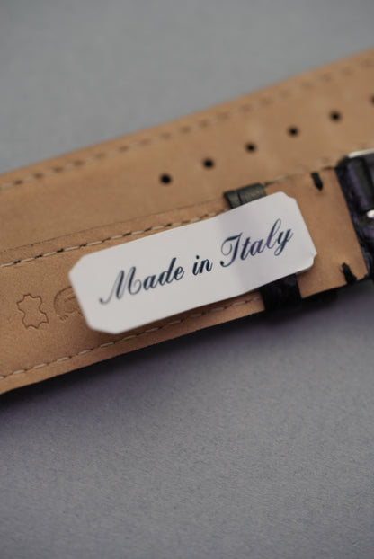 Underside of the Noir crocodile leather strap for Cartier, marked "Made in Italy" with soft tan lining and stitched edges.