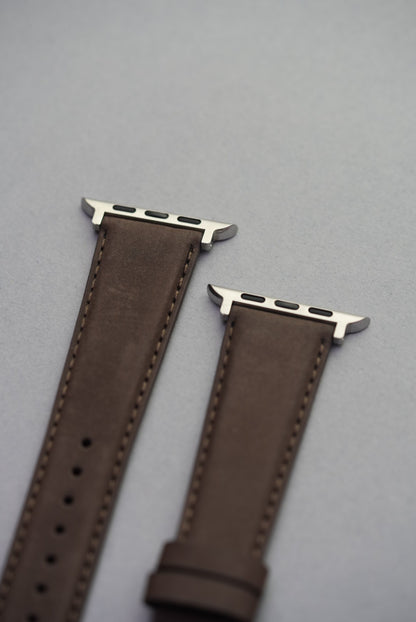  Brown nubuck strap on Apple Watch, showing matte texture and precision stitching.