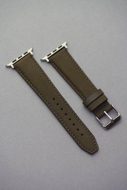 Full view of Apple Watch fitted with olive nubuck strap, showing both lugs and strap proportions.