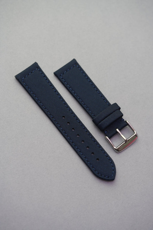 Deep ocean blue gabardine recycled watch strap with fitted buckle and stitched edges, offering a soft matte grain and smart profile.