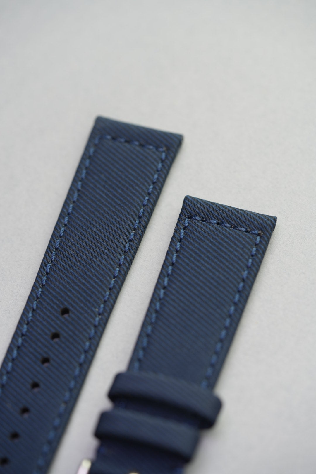 Close-up of tonal stitching on the Ocean Blue strap, highlighting the diagonal weave and remborded finish.