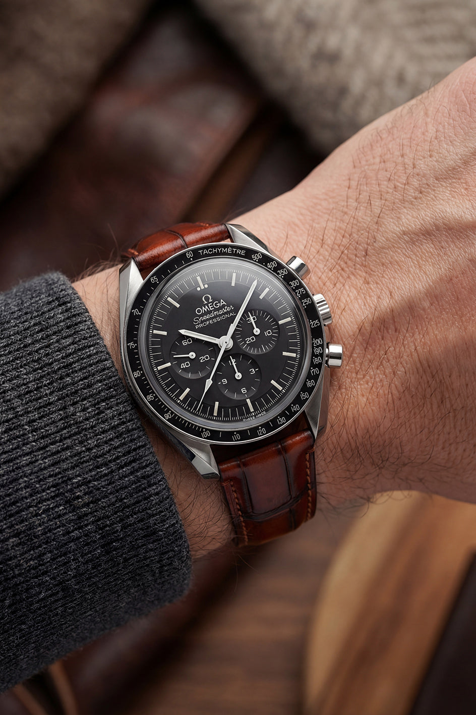 Omega Speedmaster Professional alligator-embossed calfskin leather strap replacement in light brown, flat lay showing full length and brushed stainless steel buckle