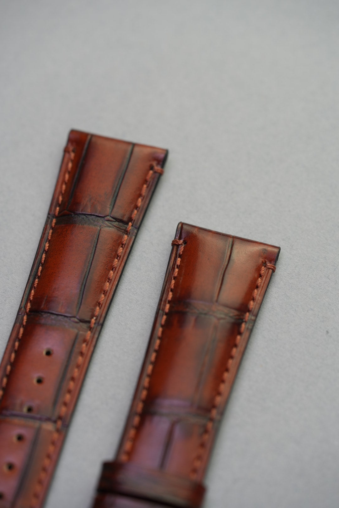  Close-up of alligator-embossed scale texture on premium calfskin leather strap for Omega Speedmaster Professional