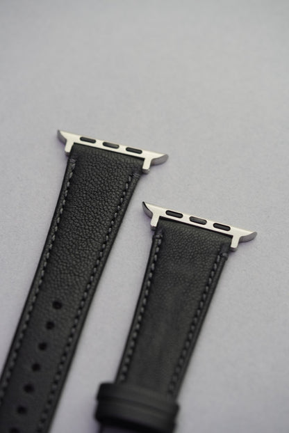 Angled close-up of Piano Noir strap paired with Apple Watch, highlighting grain texture and stitching.