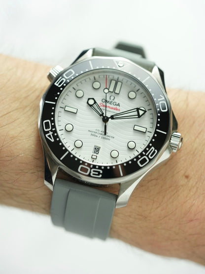 Wrist view of the Omega Seamaster, featuring the elegant grey FKM rubber strap and the watch's detailed dial design.