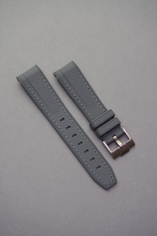 Grey rubber woven watch strap designed for Swatch x OMEGA MoonSwatch Mission to the Moon, featuring a curved edge and textured finish.
