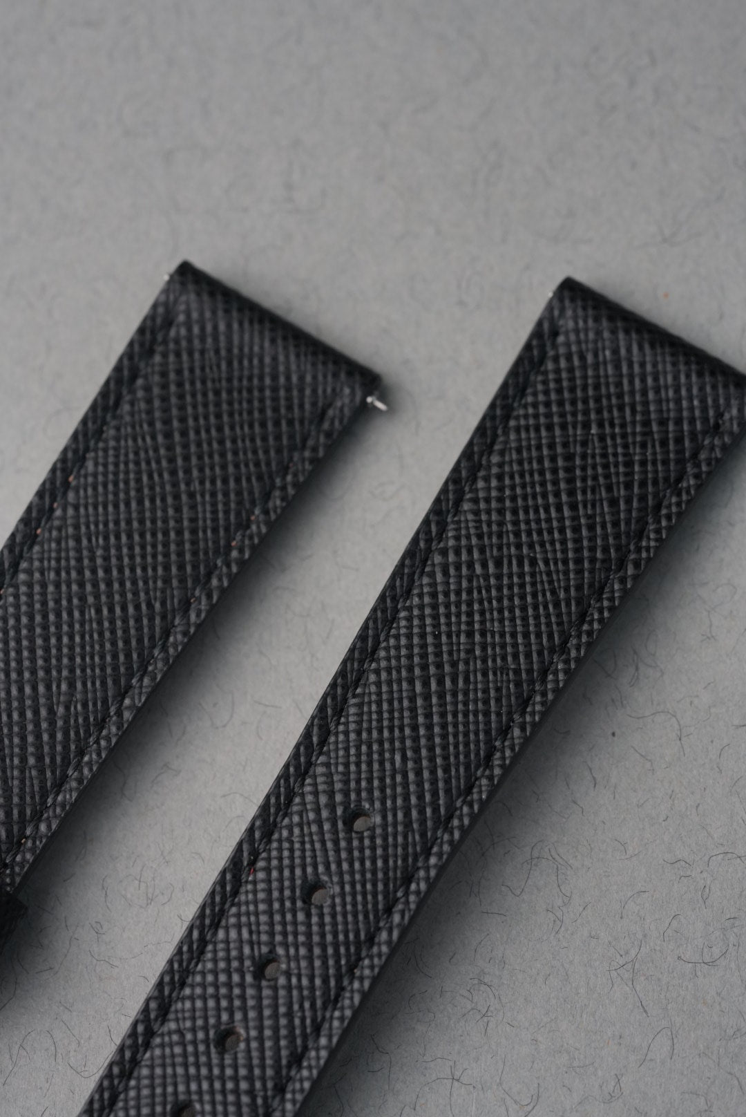 Black Italian Saffiano leather crosshatch grain texture close-up — MoonSwatch strap