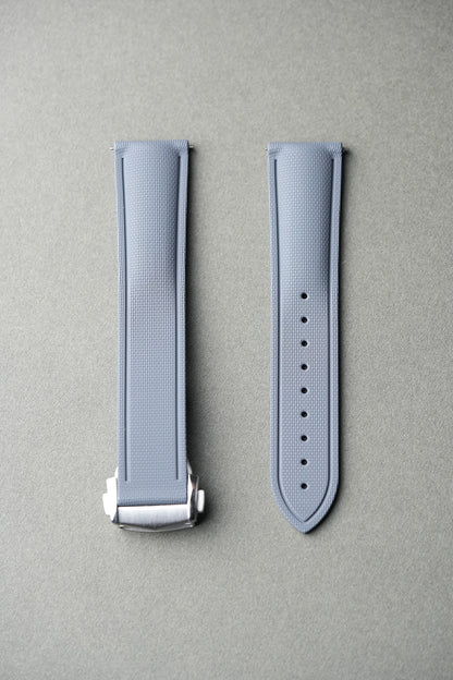 grey sailcloth deployant strap — flat lay showing textured FKM rubber and brushed steel clasp