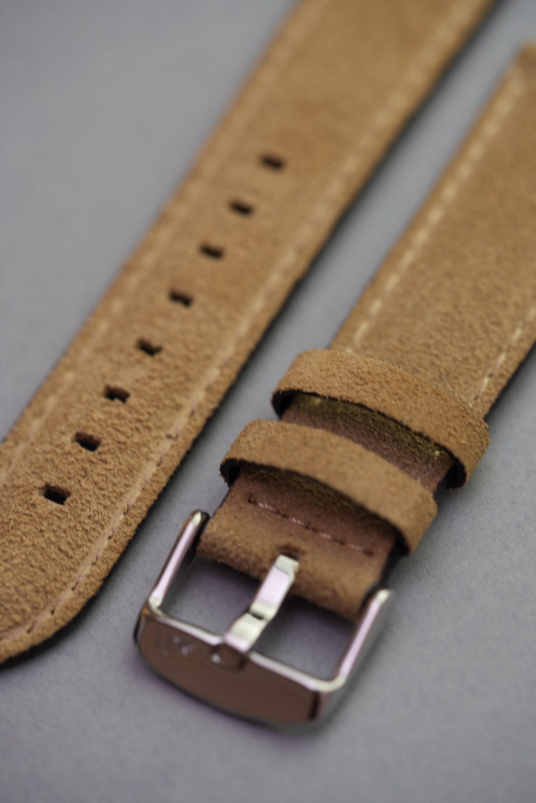 Close-up of stone suede texture and stitching on calf leather watch strap