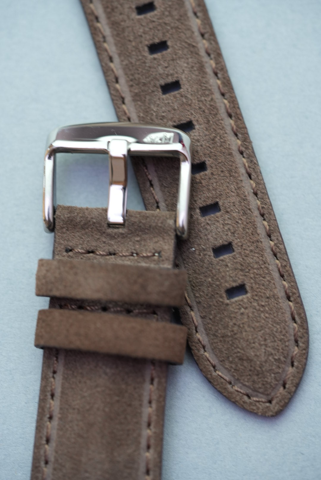 Angled front view of brown suede leather strap showing stitch and tip finish for strap replacement