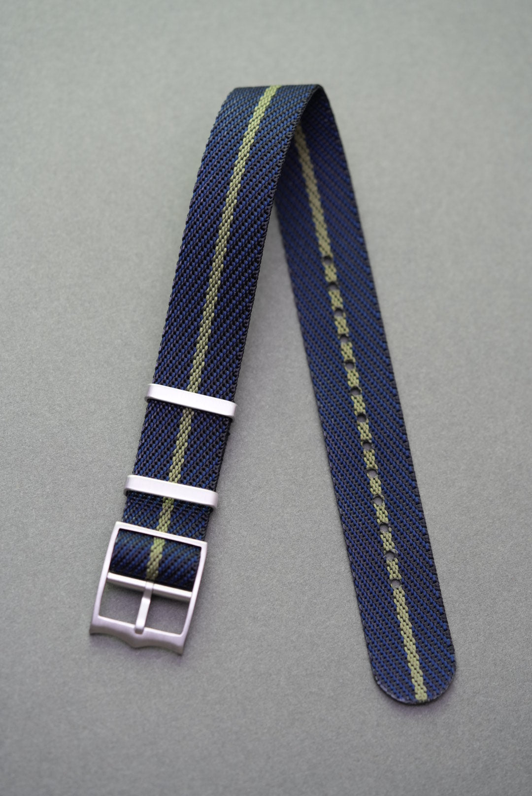 Navy single-pass nylon strap featuring a muted olive stripe, compatible with Tudor watches.