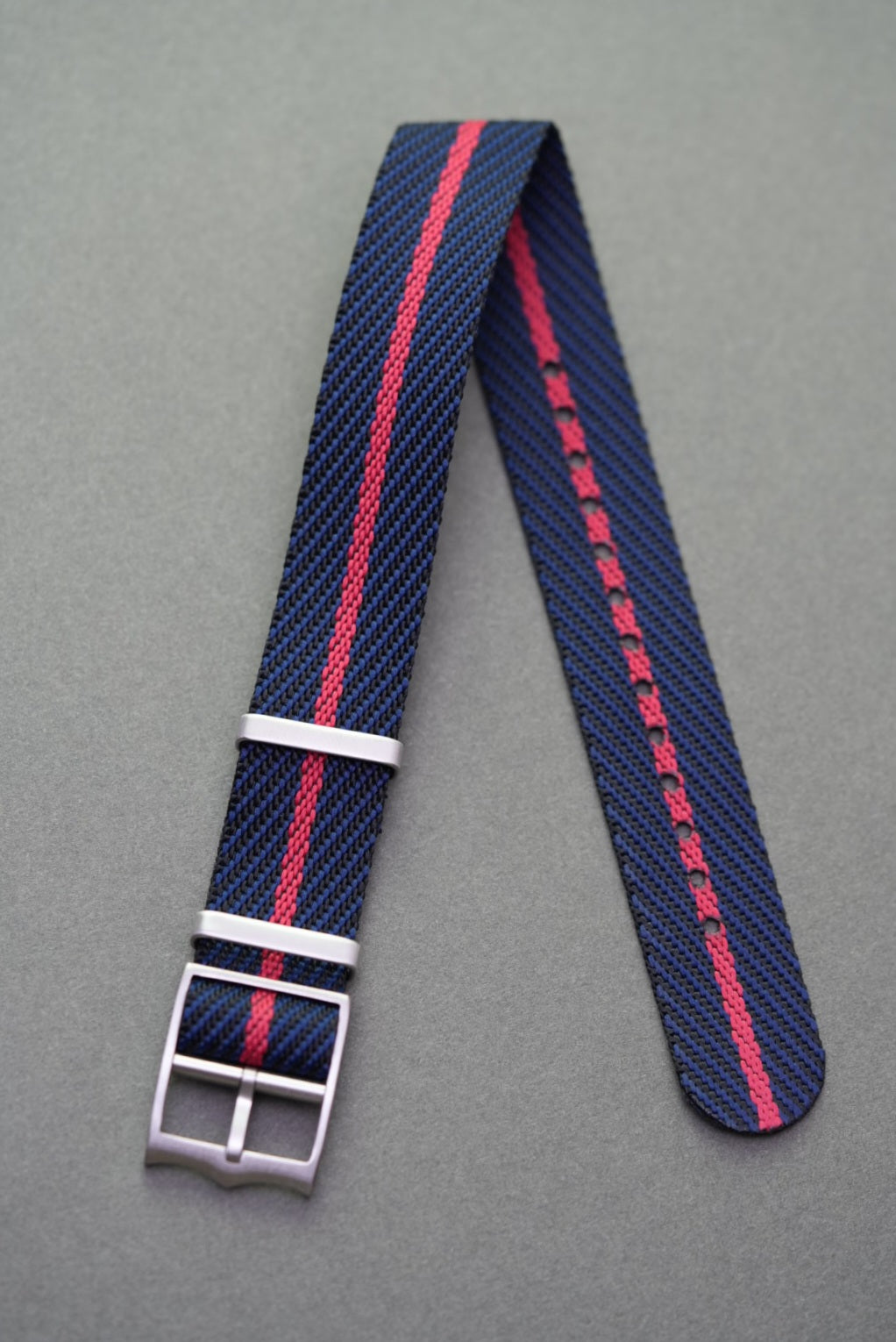 Navy woven nylon single-pass strap with bold red centre stripe, designed for Tudor watches.